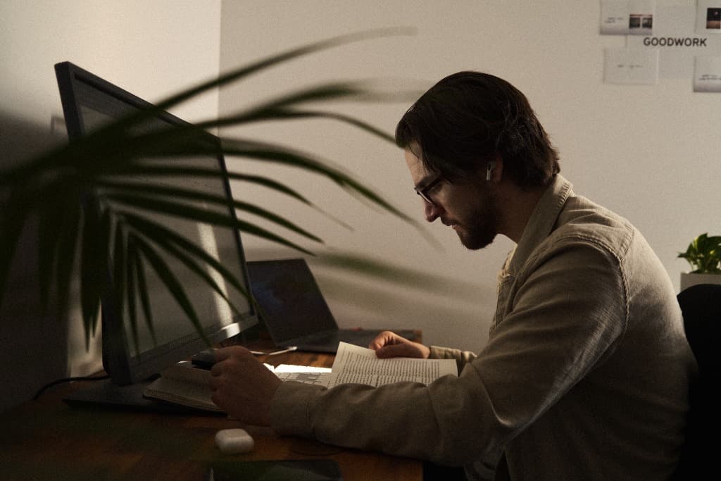 Adam Thom focused on system design and reading at his workspace